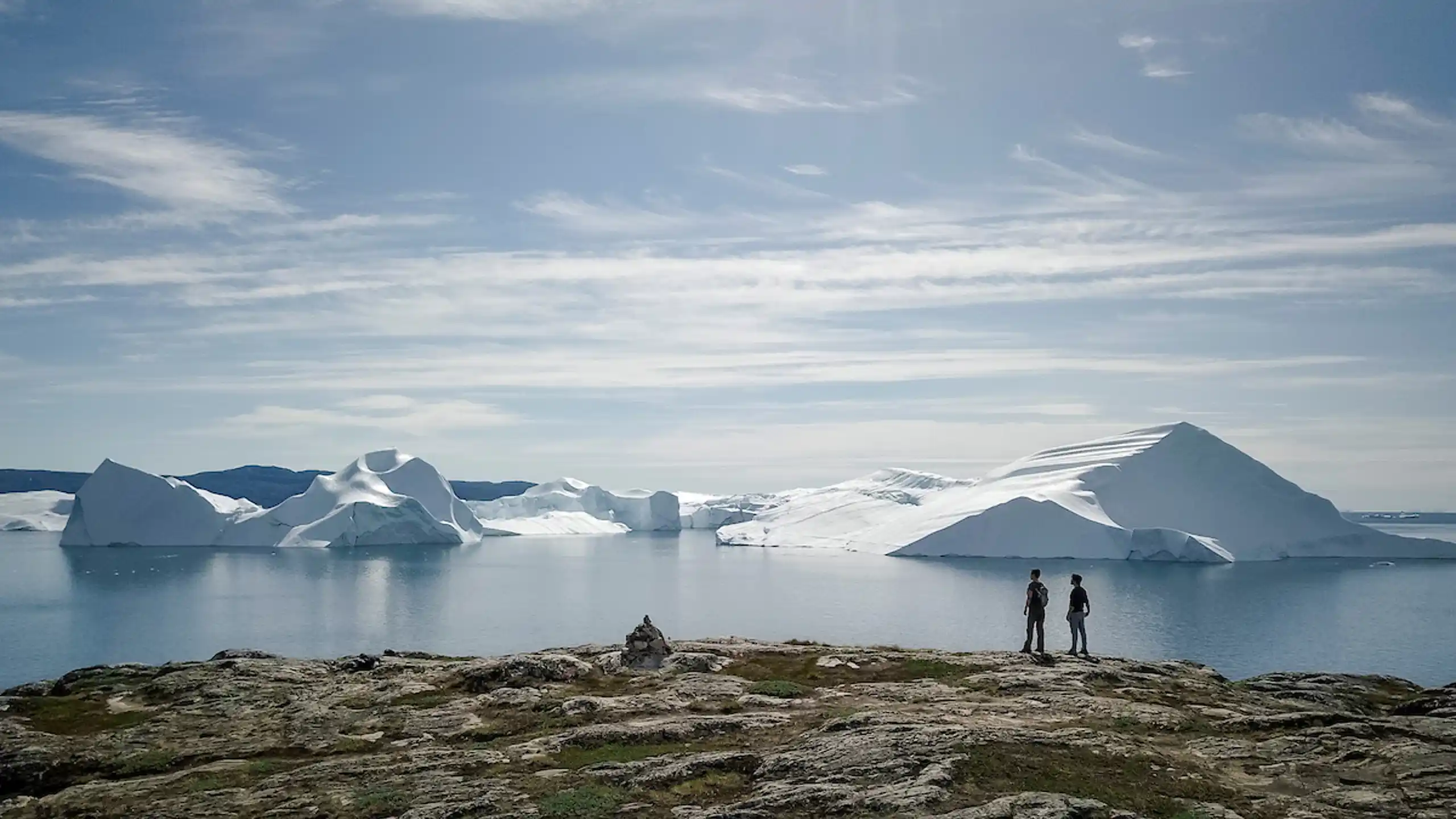 Two Hikers Look At Ilulissat Icefjord. Aningaaq Rosing Carlsen Visit Greenland