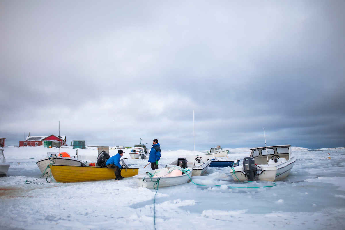 Locals In Frozen Harbour, Aasiaat. Photo Aningaaq R. Carlsen, Visit Greenland